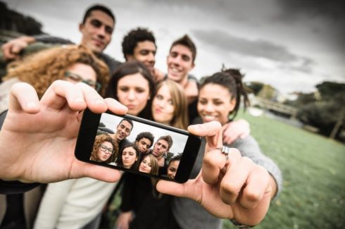 young people taking group selfie photograph